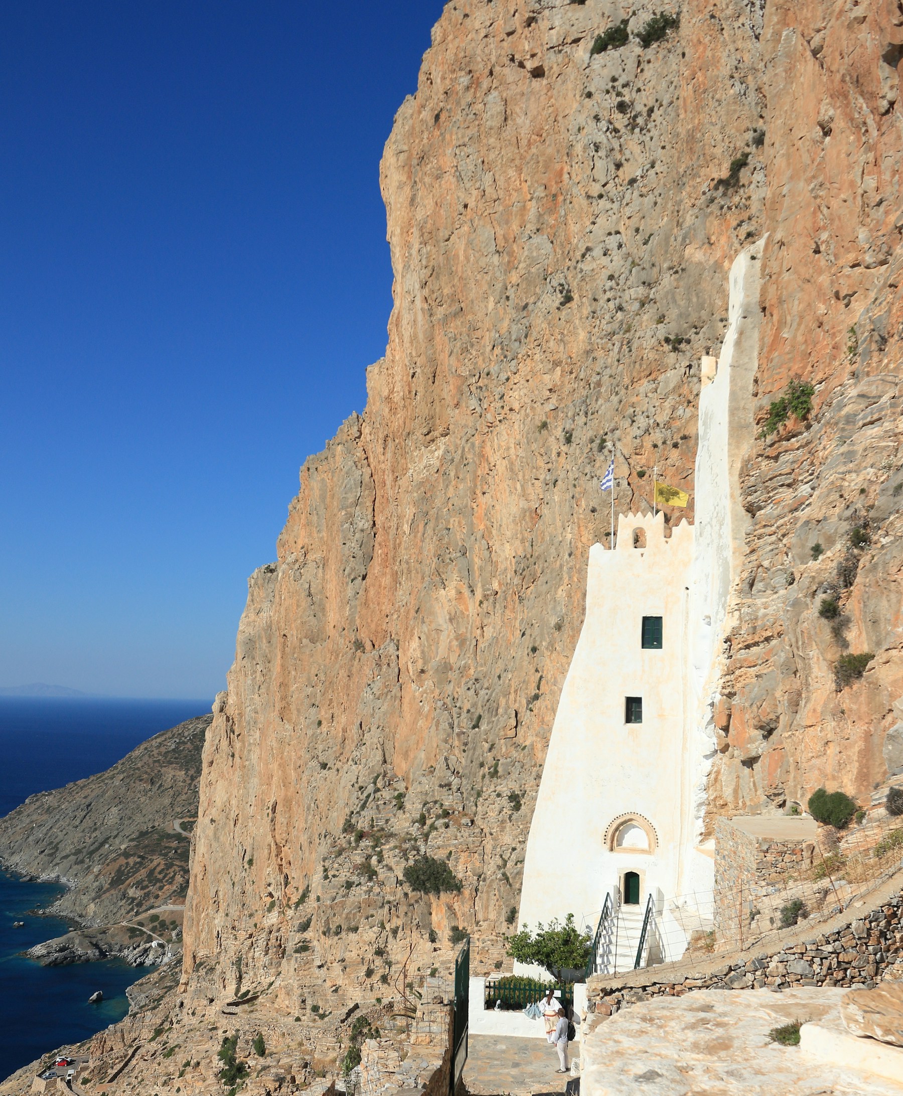The white Hozoviotissa monastery built into a cliff above the Aegean